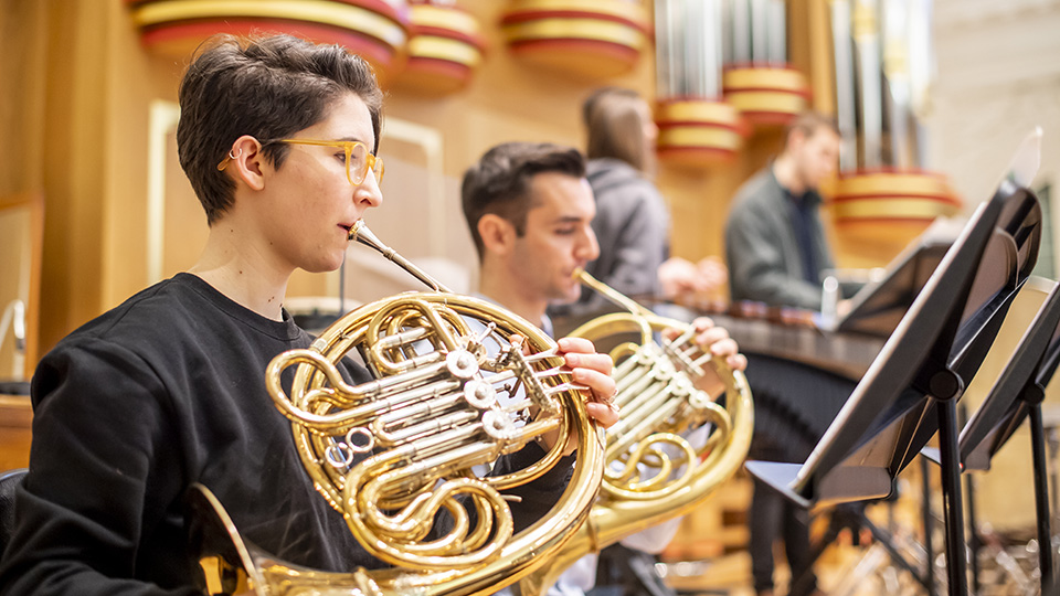 Two horn players rehearsing 